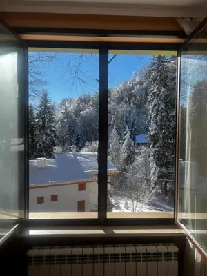 a window with a view of a snow covered yard at Фокс Хаус FOX HOUSE in Peshtera