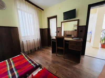 a room with a desk and a mirror and a bed at Фокс Хаус FOX HOUSE in Peshtera