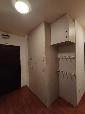 an empty room with white cabinets and a door at Apartment Melania in Complex Royal Towers in Bansko