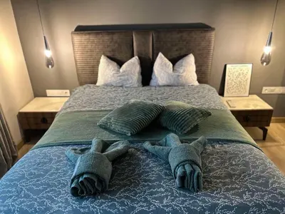 two stuffed animals are laying on a bed at Green Paradise - Luxurious Apartments in Plovdiv
