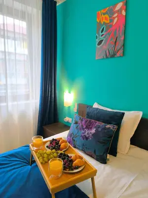 a table with a tray of fruit on a bed at Botanique - Cozy stay with free Bottle of Wine in Bansko