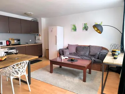 a living room with a couch and a table at Botanique - Cozy stay with free Bottle of Wine in Bansko