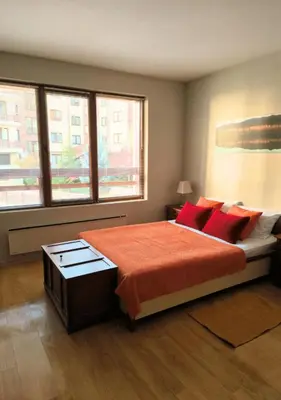 a bedroom with a large bed with red pillows at Amber - Mountain Escape with free Bottle of good Wine in Bansko