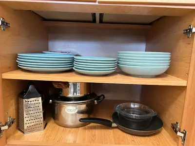 a shelf with plates and bowls in a cabinet at Mountain View, Grand Monastery Pamporovo, top location in Pamporovo