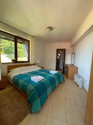 a bedroom with a bed with a blue blanket at Mountain View, Grand Monastery Pamporovo, top location in Pamporovo