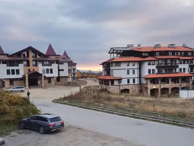 a car parked on a road in front of buildings at Apartment Melania in Complex Royal Towers in Bansko