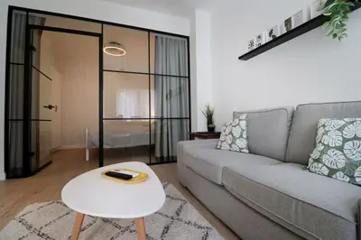 a living room with a couch and a table at Urban Chic Sofia Top Central Location in Sofia