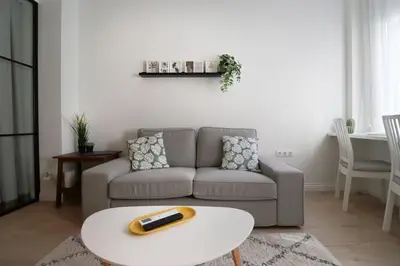 a living room with a couch and a table at Urban Chic Sofia Top Central Location in Sofia
