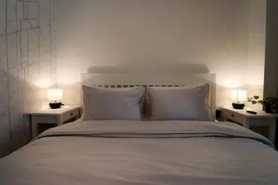 a bedroom with a bed with two lamps on tables at Urban Chic Sofia Top Central Location in Sofia