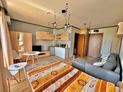 a living room with a couch and a table at St Ivan Ski and Spa Studio in Bansko