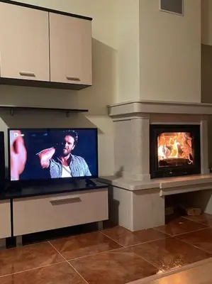 a tv in a living room with a fireplace at Прекрасно място за нощувки в Пампорово in Pamporovo
