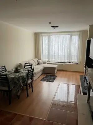 a living room with a couch and a table at Прекрасно място за нощувки в Пампорово in Pamporovo