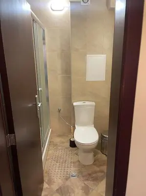 a bathroom with a toilet and a glass shower at Чудесно място за нощувки в Пампорово in Pamporovo