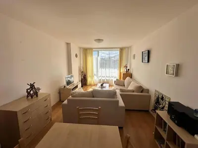 a living room with a couch and a table at Cozy apartmen with Mountain view in Bansko