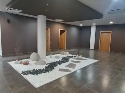 a room with a rug with rocks and plants on it at 2 Bdr Garden Apt with Spa near Ski and Golf in Razlog