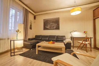 a living room with a couch and a table at Central Luxury Cozy Modern Apartment in Sofia