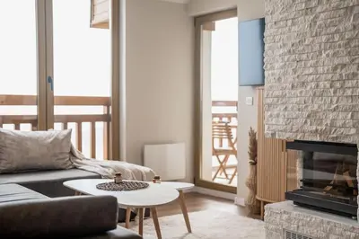 a living room with a couch and a fireplace at Host2U Penthouse Sauna, Jacuzzi, Fireplace in Bansko