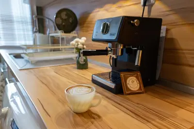 a coffee machine sitting on a counter with a cup at Groovy Olive Apartment in Troyan