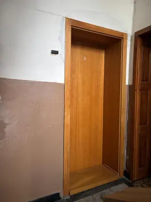 a wooden door in a room with a wall at Groovy Olive Apartment in Troyan