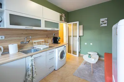 a kitchen with a sink and a washing machine at Groovy Olive Apartment in Troyan