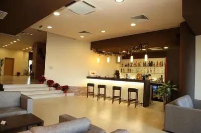 a bar in a lobby with chairs and a counter at Aspen golf & Ski resort 2 bedroom apartment E002 in Razlog