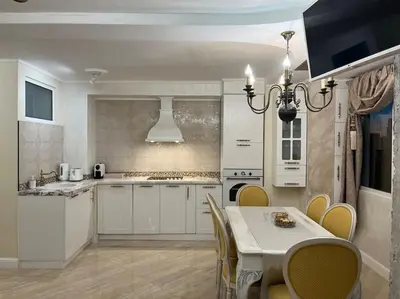 a kitchen with a table and yellow chairs in a room at Ellie Soe Apartment Free parking 5 min to Metro in Sofia