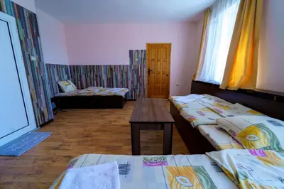 a room with two beds and a table in it at Вила Горски Кът in Yavrovo