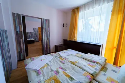 a bedroom with a bed and a large window at Вила Горски Кът in Yavrovo