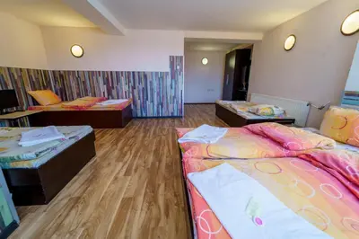 a hotel room with two beds and two tables at Вила Горски Кът in Yavrovo