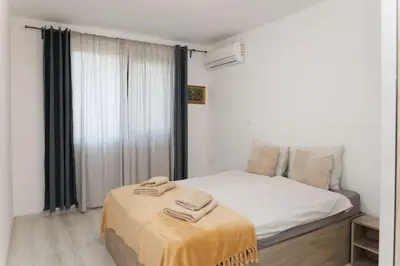 a bedroom with a bed with two towels on it at Elit Park apartment Bright & Cozy in Plovdiv