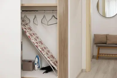 a closet with a ladder and hangers in a room at Elit Park apartment Bright & Cozy in Plovdiv