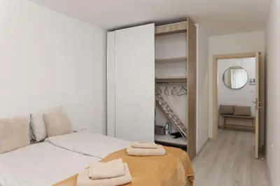 a bedroom with a bed with two towels on it at Elit Park apartment Bright & Cozy in Plovdiv