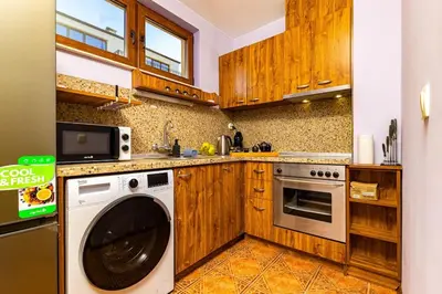 a kitchen with a washer and a dishwasher at City Center Apartment Aleko Konstantinov in Plovdiv