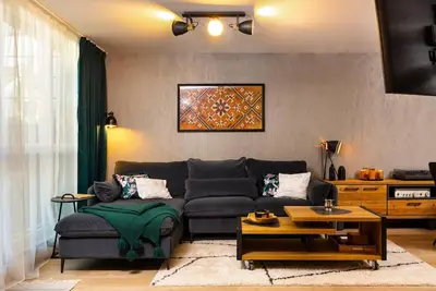 a living room with a couch and a table at Casa di Marko Stylish apt in the Center in Plovdiv