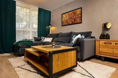 a living room with a couch and a coffee table at Casa di Marko Stylish apt in the Center in Plovdiv