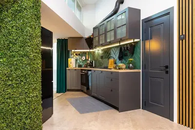 a small kitchen with a counter and a door at Casa di Marko Stylish apt in the Center in Plovdiv