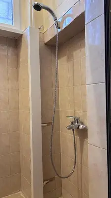 a shower with a shower head in a bathroom at Studio in the heart of Sofia in Sofia