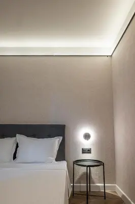a bedroom with a bed with a table next to it at M star rooms, Private Parking, Sofia TOP CENTER in Sofia