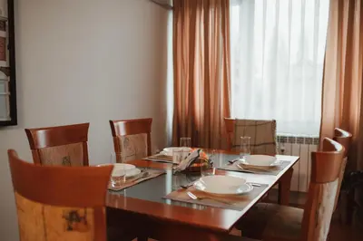 a dining room table with chairs and a table and a table and chairsktop at Apartment Rhea with Terrace & Parking in Plovdiv