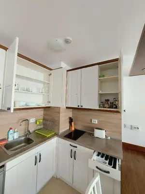 a kitchen with white cabinets and a sink at BELVEDERE Holiday Club VIP 59 in Bansko