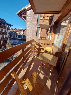 a balcony with chairs and tables on a building at BELVEDERE Holiday Club VIP 59 in Bansko