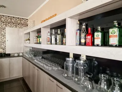 a bar with many wine glasses and bottles at Айляк Клуб Хисаря - Бутиков Хотел&СПА с Elegant Ultra All Inclusive in Hisarya