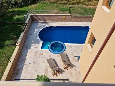 an overhead view of a swimming pool with two lawn chairs and a swimming pool at Айляк Клуб Хисаря - Бутиков Хотел&СПА с Elegant Ultra All Inclusive in Hisarya