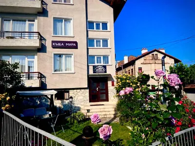 a building with flowers in front of it at Mira Guest House in Dobrinishte