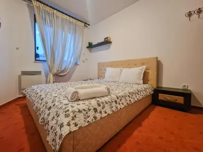 a bedroom with a bed with two towels on it at Cozy 2-Bedroom Stay with Parking in OLD INN Bansko by Flat Mаnager in Bansko