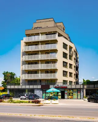 a tall building with a parking lot in front of it at Bright Windowed Studio 10 mins to the City Centre by Flat Mаnager in Plovdiv