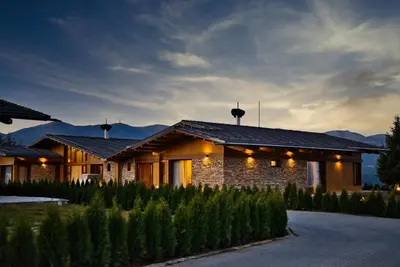 a house with lights on the side of it at Bansko Lux Villas for Ski & Chill in Razlog