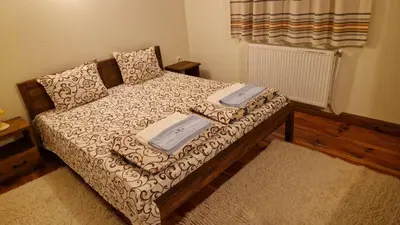 a bed in a room with two trays on it at Melnik Pyramids Guesthouse in Zlatkov Chiflik