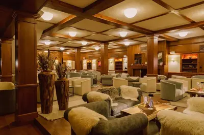 a large room with couches and chairs and tables at Уютная студия Green Life E 04 in Bansko