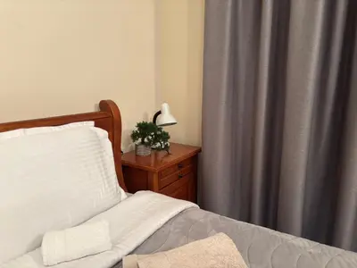 a bedroom with a bed and a table with a lamp at Bella Si Relax in Bansko